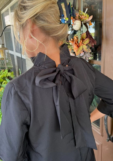 Round neck dress with ruffle hem and back strap with pockets